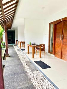 a hallway of a house with a wooden door and a table at Pererenan nengah guest house canggu in Canggu