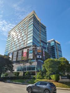a car parked in front of a tall building at First Subang Courtyard SS15 Subang Jaya Subang Parade Nu Empire Subang Taylors Campus SJMC in Subang Jaya