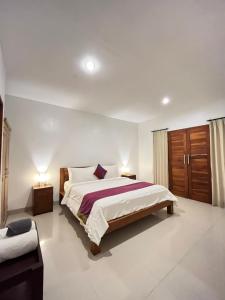 a bedroom with a large bed in a room at Pererenan nengah guest house canggu in Canggu +84 photos