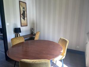 イジェにあるLa Tour Mailly - 3 pièces tout confortの部屋の中の木製のテーブルと椅子