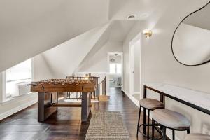 a dining room with a table and stools at NEW! Fun & style Eastside MKE Best Day Townhouse in Milwaukee