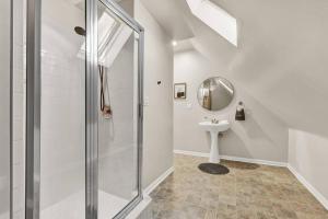 a white bathroom with a shower and a sink at NEW! Fun & style Eastside MKE Best Day Townhouse in Milwaukee