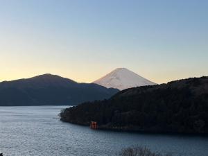 a mountain in the middle of a lake with a mountain at Fuji-Hakone Guest House in Hakone