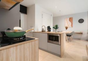 a kitchen with a green bowl on a stove at Lumi Tropicana Muji Concept in Petaling Jaya