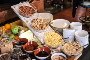 a table topped with bowls of food and bowls of nuts at Amsterdam Hotel in Belgrade