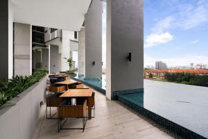 a balcony with tables and a view of a city at Lumi Tropicana Muji in Petaling Jaya