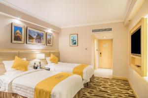 Voodi või voodid majutusasutuse Metropark Hotel Macau toas
