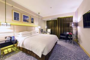 Voodi või voodid majutusasutuse Metropark Hotel Macau toas