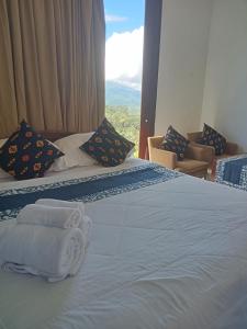 a hotel room with a bed with towels on it at The Bunut Villas in Kubupenlokan