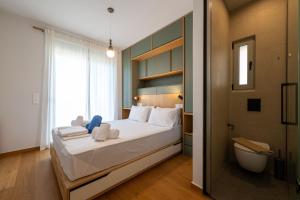 a bedroom with a large bed and a bathroom at Cella Villa in Kalamata
