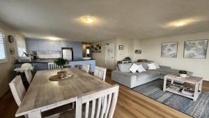 a kitchen and living room with a table and a couch at Sandy Cove Unit 6 in Caloundra