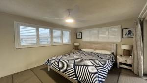 a bedroom with a bed and a ceiling fan at Sandy Cove Unit 6 in Caloundra