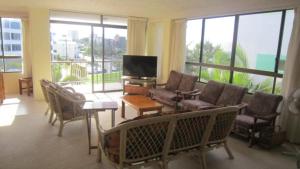 a living room with a couch and chairs and a television at Seamist Lodge Unit 5 in Caloundra