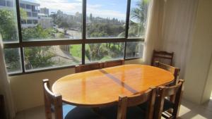 a wooden table in a room with a large window at Seamist Lodge Unit 5 in Caloundra