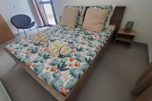 a bed in a room with a pineapple and palm leaves at Clairs Moments in Saint-Pierre