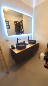 a bathroom with two sinks and a large mirror at Clairs Moments in Saint-Pierre +30 photos