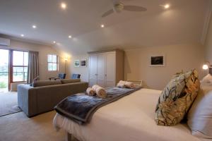 a bedroom with a large bed and a couch at Raptor Rise Farm in Tulbagh +74 photos
