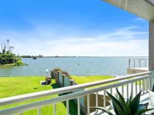 a view of the water from the balcony of a house at Yarrawonga Lakeside Apartment 50 in Mulwala