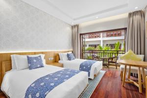 Voodi või voodid majutusasutuse Wafaifo Resort Hoi An toas