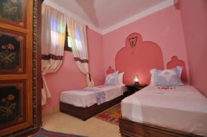 Cama o camas de una habitación en Riad La Famille
