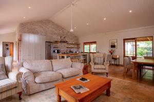 a living room with a couch and a table at Raptor Rise Farm in Tulbagh