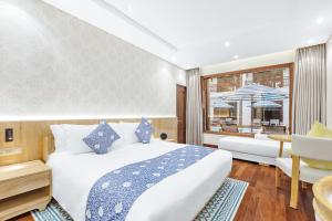 Voodi või voodid majutusasutuse Wafaifo Resort Hoi An toas