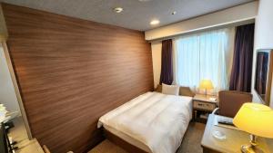 A bed or beds in a room at Platon Hotel Yokkaichi
