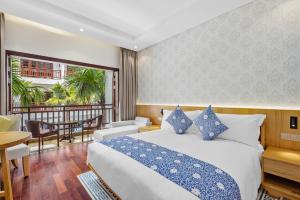 Voodi või voodid majutusasutuse Wafaifo Resort Hoi An toas
