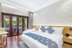 Voodi või voodid majutusasutuse Wafaifo Resort Hoi An toas