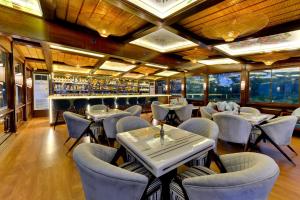 a restaurant with chairs and tables and a bar at Chacha Inn The Garden Retreat in Mount Ābu