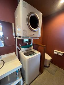 a bathroom with a washing machine and a dryer at Karisome in Motobu +63 photos