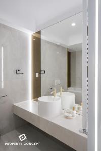 a bathroom with a white sink and a mirror at Cortina Concept Studio 128 in Voluntari +42 photos