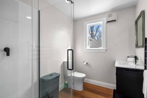a bathroom with a shower and a toilet and a window at Morgan's Treasure in Hanmer Springs +13 photos