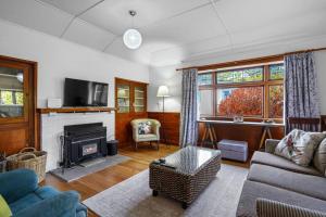 a living room with a couch and a fireplace at Morgan's Treasure in Hanmer Springs