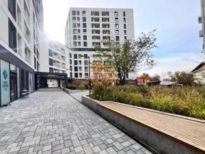 a walkway in a city with tall buildings at NEO Sapte - central - City of Mara in Timişoara