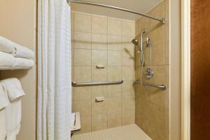 a shower stall in a bathroom with a shower curtain at Candlewood Suites NYC -Times Square by IHG in New York +64 photos