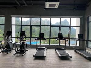 a gym with several exercise bikes in a room with windows at Sunway City Ipoh Tambun Onsen Cozy Retreat 8pax in Tambun