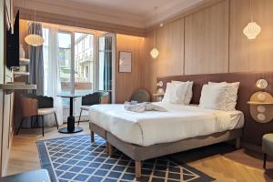 a hotel room with a bed and a table at Aparthotel AMMI Nice Lafayette in Nice