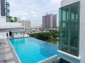 a pool on the roof of a building with a view at Setapak Central Premium Suites in Kuala Lumpur