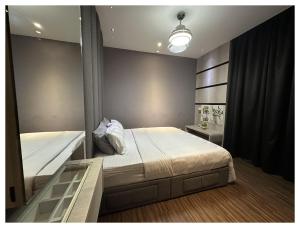 a bedroom with two beds and a mirror at Setapak Central Premium Suites in Kuala Lumpur +28 photos