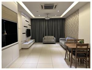 a living room with a couch and a table at Setapak Central Premium Suites in Kuala Lumpur