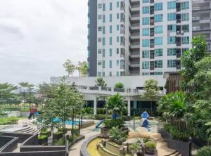 a park in front of a tall building at Setapak Central Premium Suites in Kuala Lumpur
