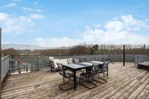 a patio with a table and chairs on a deck at 3 BR Duplex in Wiedikon in Zürich