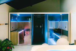 a glass elevator with blue lights in a room at Camping Lou Broustaricq in Sanguinet +49 photos