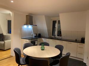 a kitchen with a table and chairs in a room at 3 BR Duplex in Wiedikon in Zurich