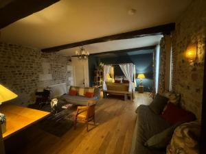 a living room with a couch and a table at La Cour Sainte Catherine demeure de charme in Honfleur