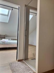 a sliding glass door in a room with a bedroom at Appartement Zen & Cosy in Ambérieu-en-Bugey