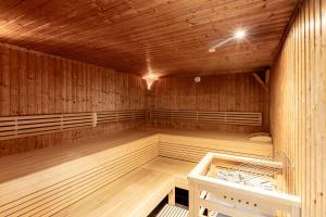 a large empty sauna with wooden walls and ceilings at Bellevue Residences - Luxurious Lakeside Apartments in Zell am See