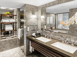 a bathroom with two sinks and a large mirror at Mandarin Oriental, Jakarta in Jakarta