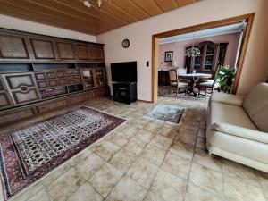 a living room with a couch and a table at Einzelzimmer am Main in Knetzgau